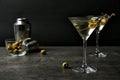 Glasses of Classic Dry Martini with olives on grey table Royalty Free Stock Photo
