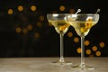 Glasses of Classic Dry Martini with olives on grey table against blurred background Royalty Free Stock Photo