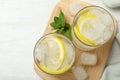 Glasses of cocktail with vodka, ice and lemon on wooden table, top view Royalty Free Stock Photo