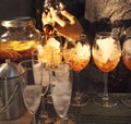 Barman preraring aperol spritz cocktail in outdoor summer bar