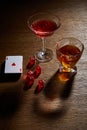Glasses of cognac and cocktail near deck of cards and dice on wooden background Royalty Free Stock Photo