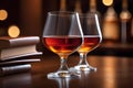 Glasses of Cognac with Vintage Books on a Wooden Bar Counter in a Cozy English Pub