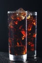 Glasses of cola with ice cubes on black stone Royalty Free Stock Photo