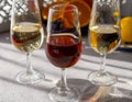 Glasses with cold dry fino and sweet cream sherry fortified wine and orange in sunlights, andalusian style interior on background Royalty Free Stock Photo