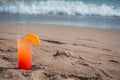 Glasses with colored cocktails on the beach