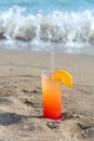 Glasses with colored cocktails on the beach