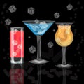 Glasses of colorful drinks with ice cubes, set of summer tropical cocktail isolated on black background