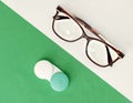 Glasses and contact lenses are white and green background. The concept of vision and choice