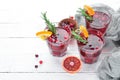 Glasses with cranberry juice. Cranberries, limes, rosemary. On a rustic background. Top view. Royalty Free Stock Photo