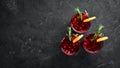 Glasses with cranberry juice. Cranberries, limes, rosemary. On a rustic background. Top view. Royalty Free Stock Photo