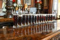 glasses of dark beer lined up on a bar with traditional pub decor Royalty Free Stock Photo