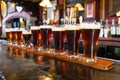 glasses of dark beer lined up on a bar with traditional pub decor Royalty Free Stock Photo