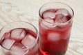 Glasses of delicious iced hibiscus tea on white wooden table, closeup Royalty Free Stock Photo