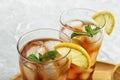 Glasses of delicious iced tea on marble table