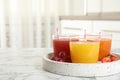 Glasses of delicious juices and fresh fruits on white marble table. Space for text Royalty Free Stock Photo