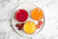 Glasses of delicious juices and fresh fruits on white marble table Royalty Free Stock Photo