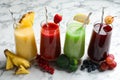 Glasses of delicious juices and fresh ingredients on white marble table Royalty Free Stock Photo