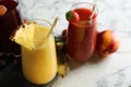 Glasses of delicious juices and fresh ingredients on white marble table, closeup Royalty Free Stock Photo