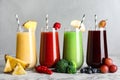 Glasses of delicious juices and fresh ingredients on white marble table Royalty Free Stock Photo