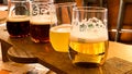 Glasses with different kinds of craft beer on a wooden bar. Tap the beer in a pint in a row. Royalty Free Stock Photo