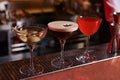 Glasses of different Martini cocktails on bar counter Royalty Free Stock Photo