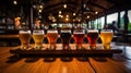 Glasses with different sorts of craft beer on wooden bar. Tap beer in pint glasses arranged in a row Royalty Free Stock Photo