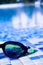 Glasses for diving on the edge of a summer pool Royalty Free Stock Photo