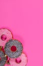 Glasses donuts on pink background. Christmas toy: chocolate and pink donats. Merry Christmas and Happy New Year concept. Royalty Free Stock Photo