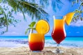 Glasses with a drink sex on the beach on the sand and a beach paradise in the background Royalty Free Stock Photo