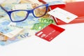 Glasses on euro currency, notebook and credit cards. Copy space.