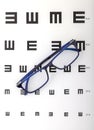 Glasses on a eye check chart Royalty Free Stock Photo