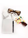 Glasses, eye drops, pills of vitamins for vision, notebook, pen, bottle. Top view space for text.