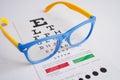 Glasses on eye exam chart to test eyesight accuracy of reading Royalty Free Stock Photo