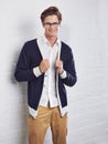 Glasses, fashion and portrait of man by wall with casual, cool and trendy outfit for confidence. Smile, handsome and Royalty Free Stock Photo