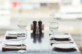 Glasses, fork, knife served for dinner in restaurant with cozy interior Royalty Free Stock Photo