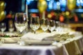 Glasses, forks, knives, napkins and decorative flower on a table served for dinner in cozy restaurant. Royalty Free Stock Photo