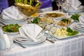 Glasses, forks, knives, napkins and decorative flower on a table served for dinner in cozy restaurant. Royalty Free Stock Photo