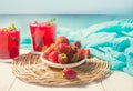 Glasses with fresh homemade strawberry sweet iced tea or cocktail, lemonade with mint and plate with strawberry. Refreshing cold Royalty Free Stock Photo