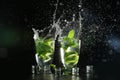 Glasses of fresh mojito with splashes on dark background Royalty Free Stock Photo
