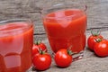 Glasses of fresh tomato juice on table