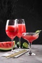 Glasses with fresh watermelon smoothie on grey table against dark background Royalty Free Stock Photo