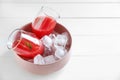 Glasses with fresh watermelon smoothie and ice cubes in bowl on white wooden table Royalty Free Stock Photo