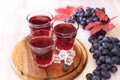 Glasses of grape juice with ice and black grapes Royalty Free Stock Photo