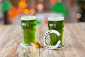 Glasses of green beer, horseshoe and gold coins Royalty Free Stock Photo