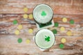 Glasses of green beer with shamrock from top