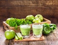 Glasses of green juice with apple, celery and spinach