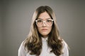 Glasses, hair and portrait of girl geek in studio on gray background for accessories or fashion. Face, intelligence and