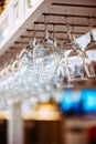 Glasses hanging above bar rack Royalty Free Stock Photo