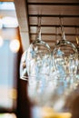 Glasses hanging above bar rack. Royalty Free Stock Photo