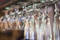 Glasses hanging on bar rack close up